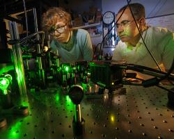 Abdelghani Laraoui (right), assistant professor of mechanical and materials engineering, and Ben Hammons, a first-year student in electrical and computer engineering, adjust a laser in Laraoui's Quantum Sensing & Defect Discovery and Spectroscopy Lab.