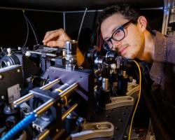 Adam Erickson from Abdelghani Laraoui’s lab in the Engineering Research Center aligns the nitrogen vacancy scanning probe microscope used for the study.