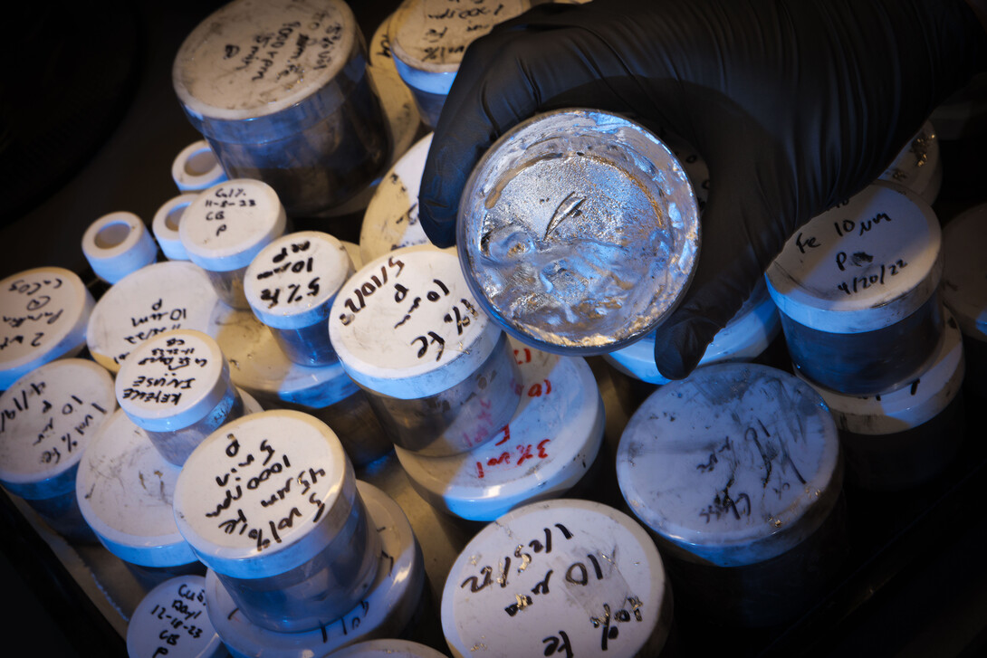 Graduate student Ethan Krings holds a sample of room-temperature, non-toxic liquid metals.