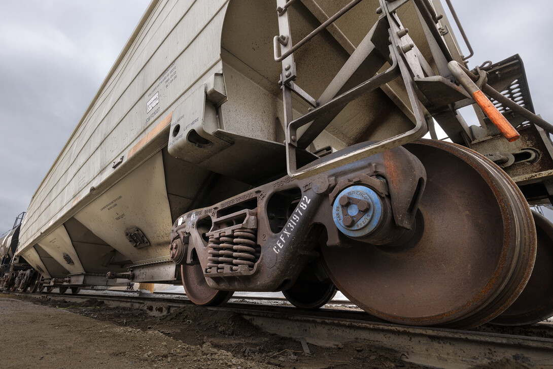 A blue Brenco railcar axle bearing is shown on a railcar. Each railcar has more than 350 bearings to support the load and keep the wheels turning. This railcar was photographed in the Omaha, Lincoln and Beatirce Railway yard with permission from the railway.