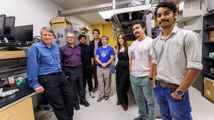 Herman Batelaan (left) stands with Marlon Weiss, Sajid Raihan Akash, Ryan O’Donnell, Wyatt Balters, Marie Rioux, Raul Puente and Arjun Mohanan in their lab in the basement of Jorgensen Hall.