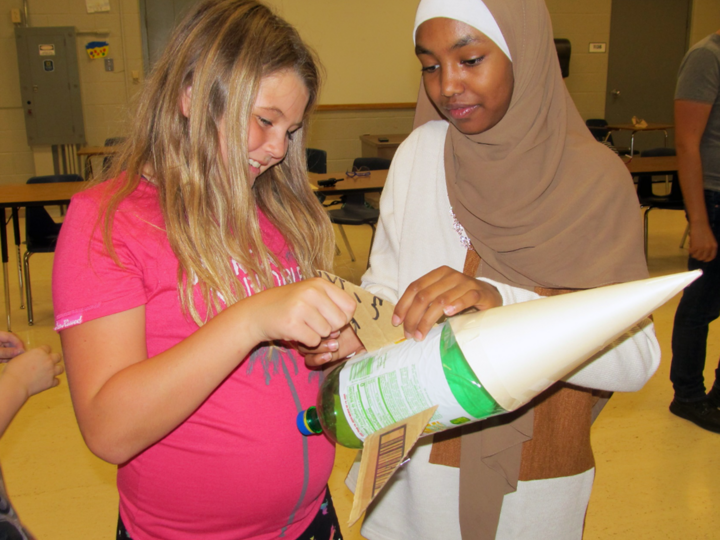 Two girls working on a project together.